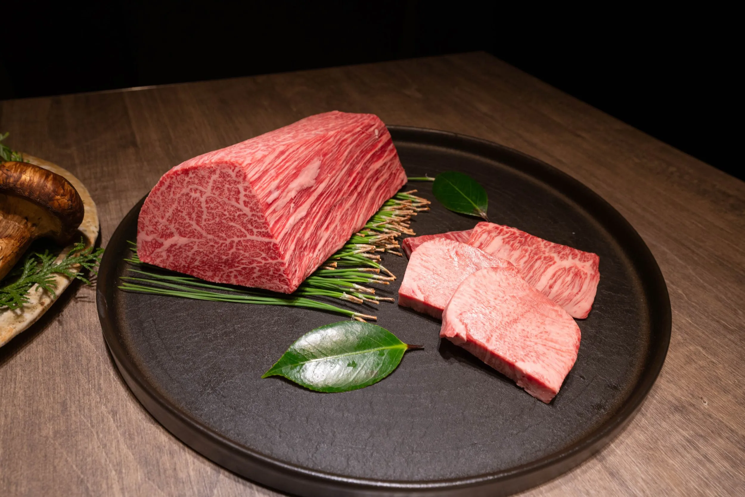 The wagyu block and sliced cuts on a dark plate