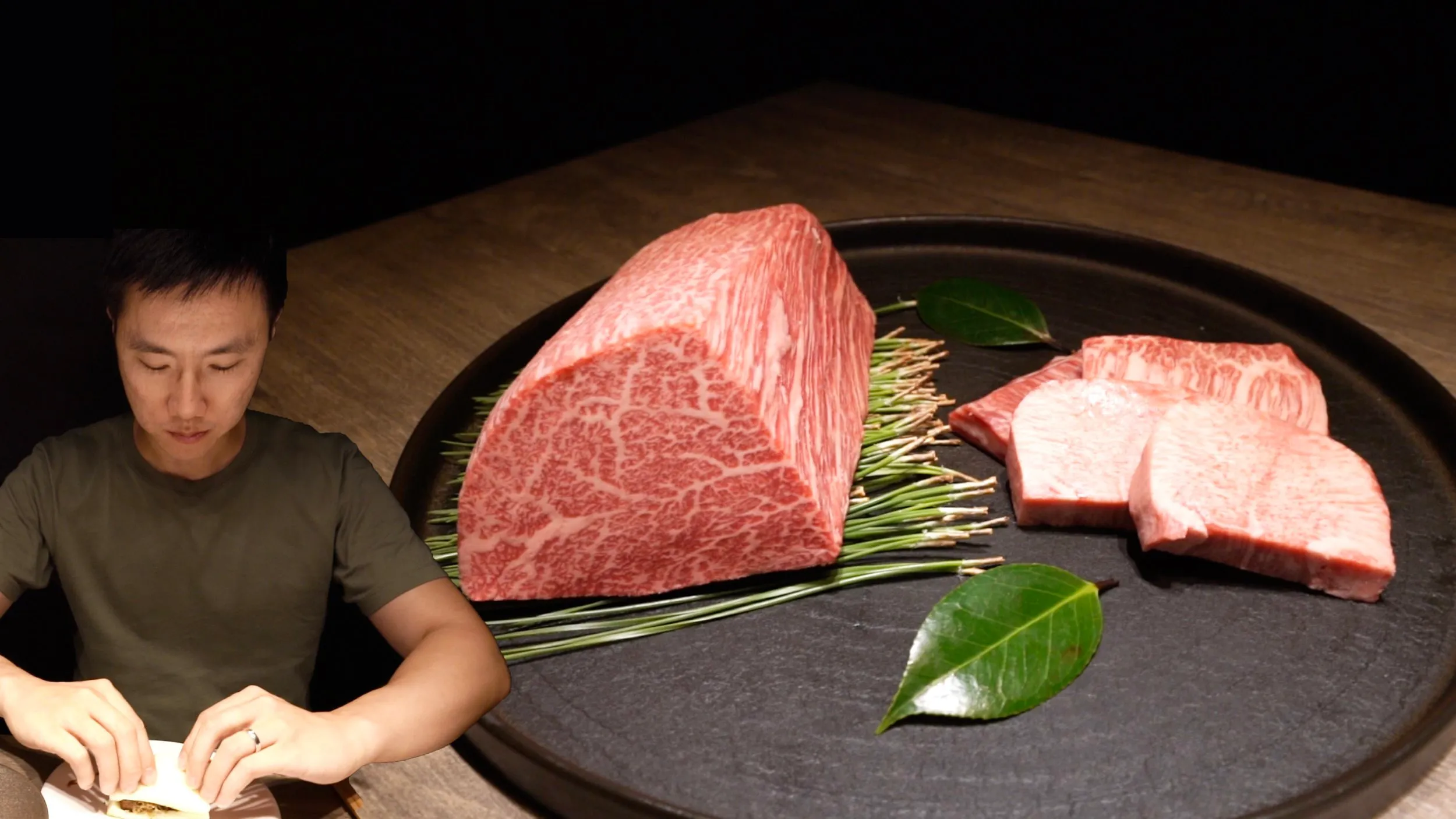 Jerry at the table behind a large block of marbled wagyu and sliced cuts